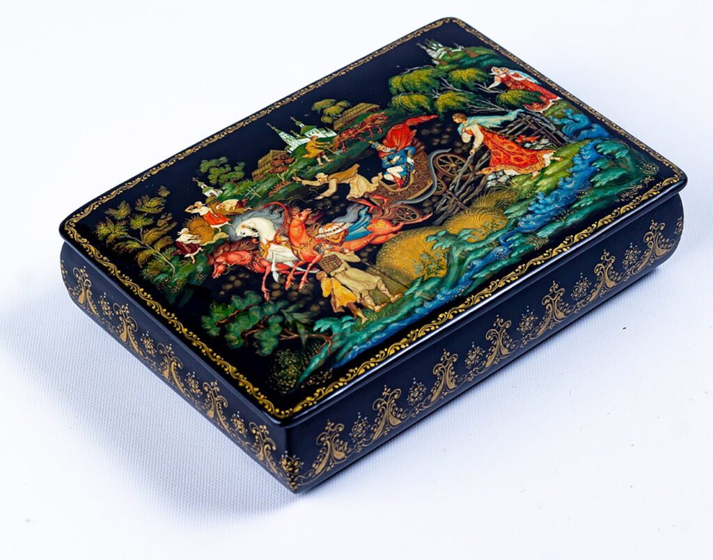 A detailed Palekh lacquer box depicting a scene from a Russian fairy tale with gold highlights on a black background, Papier-mâché and tempera